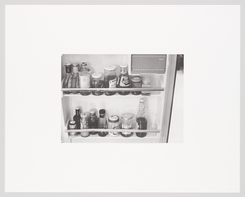 Refrigerator door shelves holding jars and bottles of condiments and sauces.