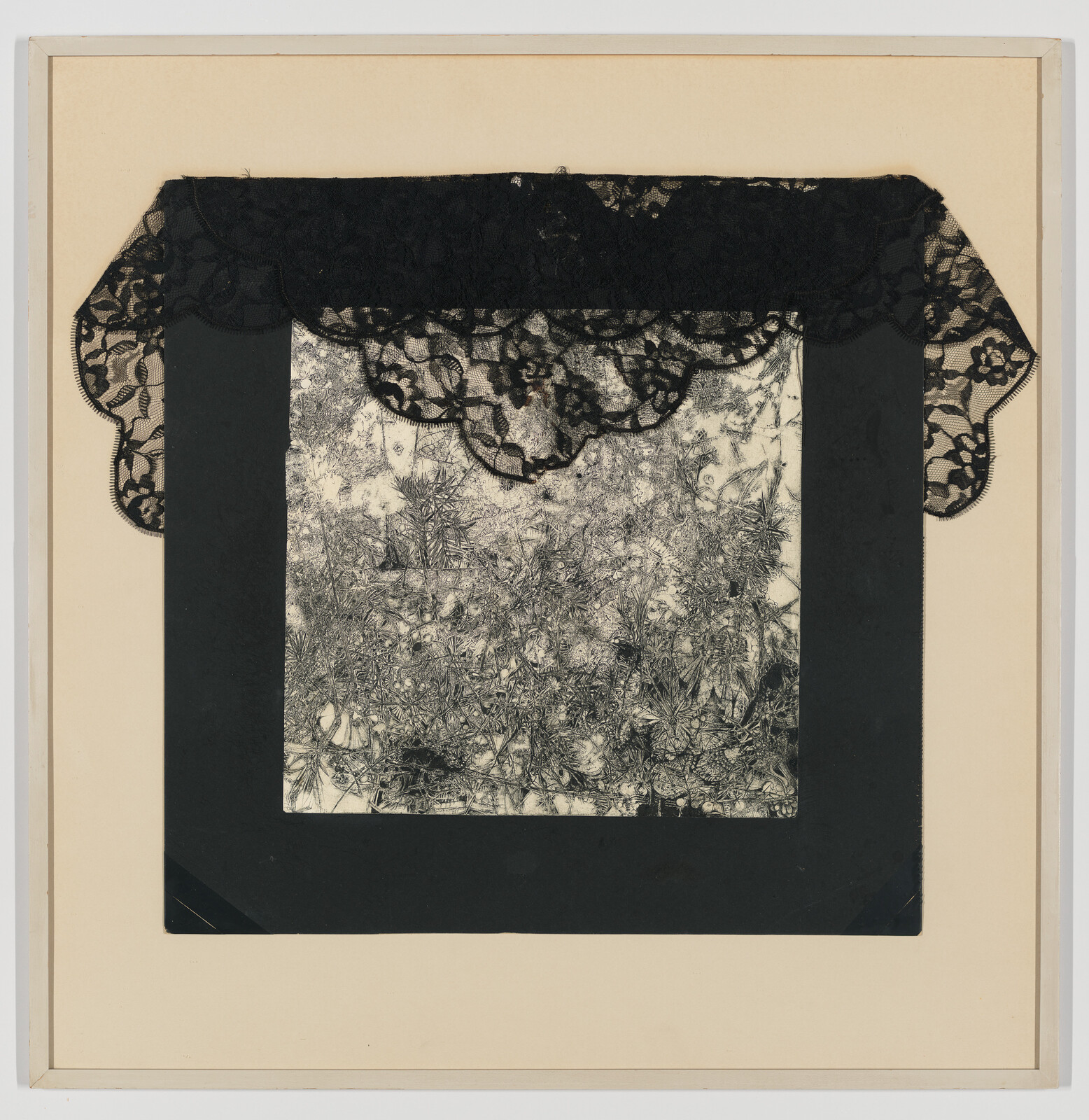 Black lace drapes over a square black-and-white textured print mounted on a beige mat.