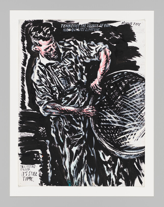 A man in work clothes leaning over and churning the contents of a large vat.