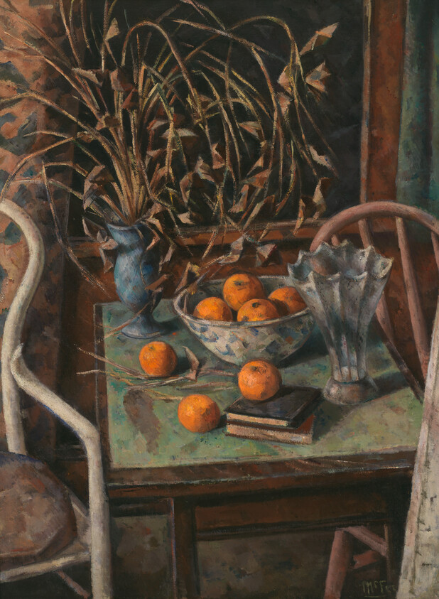 A table with a bowl of oranges, scattered fruit, vases, books, and dried plants.