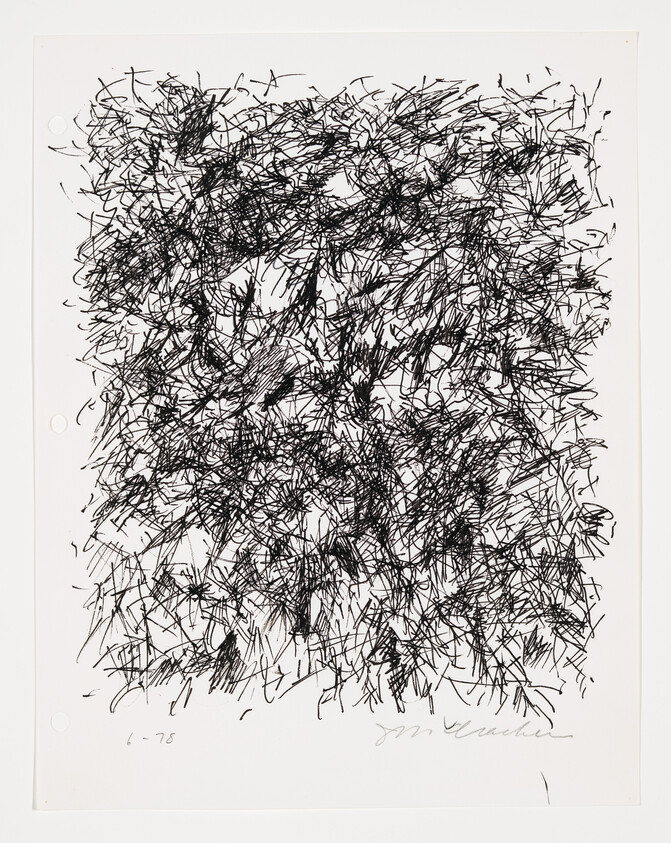 Dense black ink scribbles covering most of a white sheet of paper.