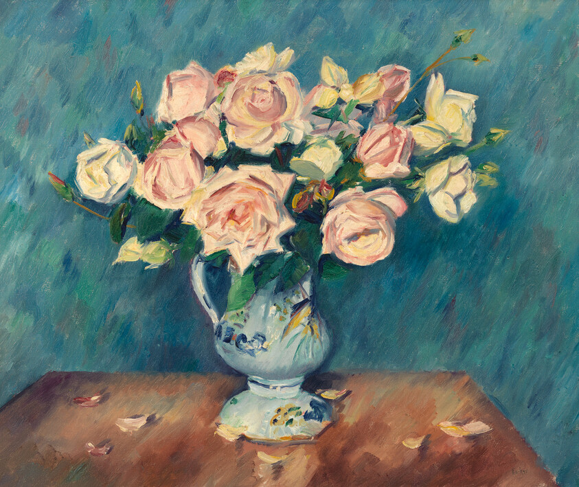 A ceramic vase filled with pale pink roses sits on a wooden table with fallen petals.