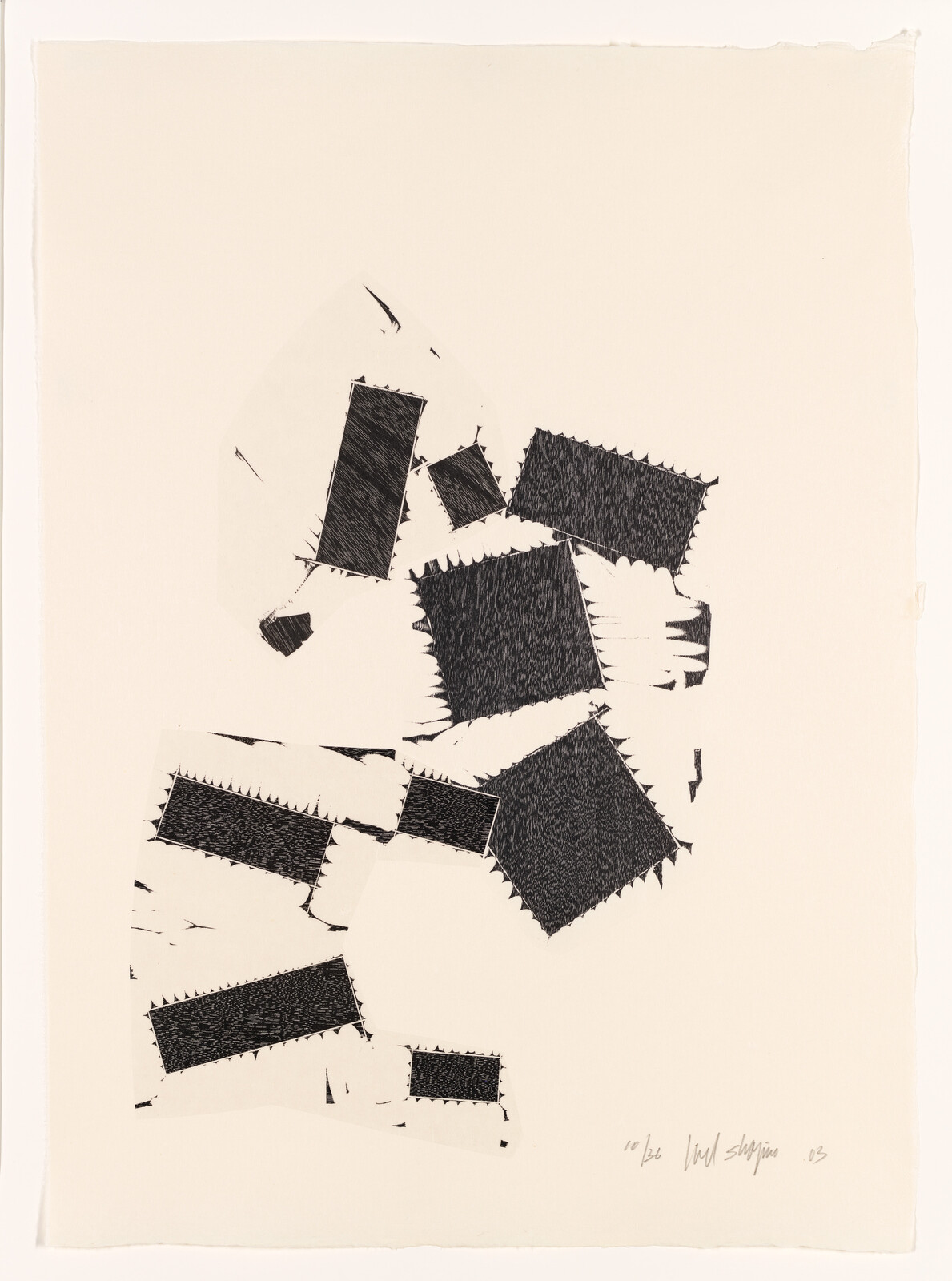 Several black textured rectangular patches with jagged edges are scattered on a cream paper background.