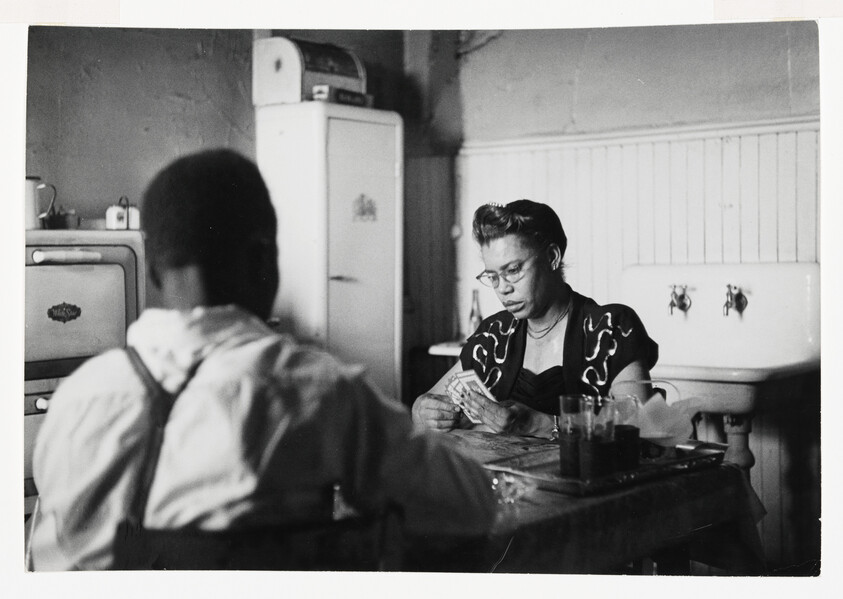 		Working with LIFE Magazine, Parks returned to Fort Scott, Kansas to track down and photograph eleven of his junior high classmates to consider the impact of segregated schooling. The majority of the photos from this series were taken in Kansas but he also traveled to see some of his classmates that had moved away -- to Chicago, Cleveland, Detroit, and Saint Louis. 				 				The Parks Foundation has digitized an image from this series which I'm certain is a portrait of the man who is seen from behind in the Whitney's print (see below). I haven't been able to find the names of the people photographed here, but from the caption provided by the foundation, this image was taken in Chicago. 				 				This cover story on segregation was shelved and never published by LIFE.  In 2015, the MFA Boston exhibited many of these works together in the exhibition "Gordon Parks: Back to For Scott."  Image url: https://www.gordonparksfoundation.org/gordon-parks/photography-archive/back-to-fort-scott-1950?view=slider#10  