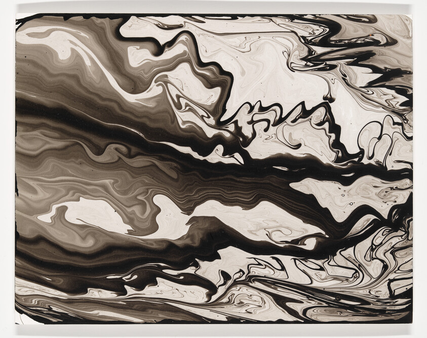 Black and white marbled swirls flow across the canvas in bold, fluid patterns.