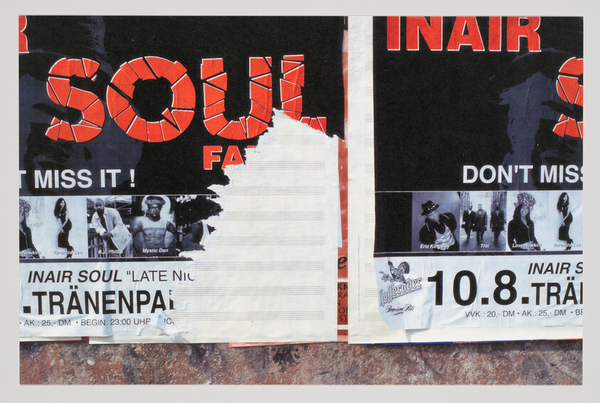 Torn concert posters advertising a soul music event plastered on a wall, date 10.8 visible.