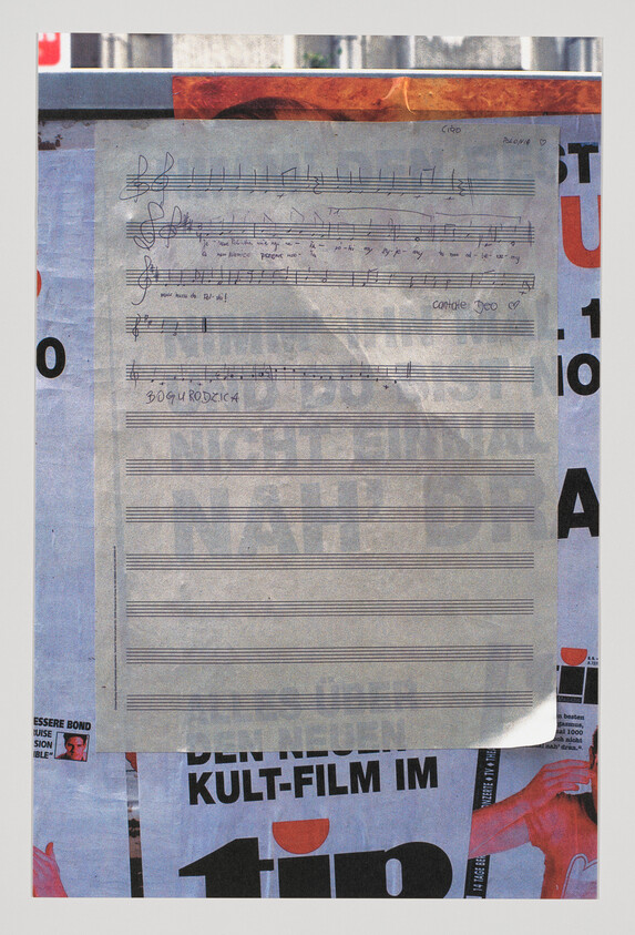 A sheet of handwritten musical notation titled "Bogurodzica" taped over a colorful poster background.