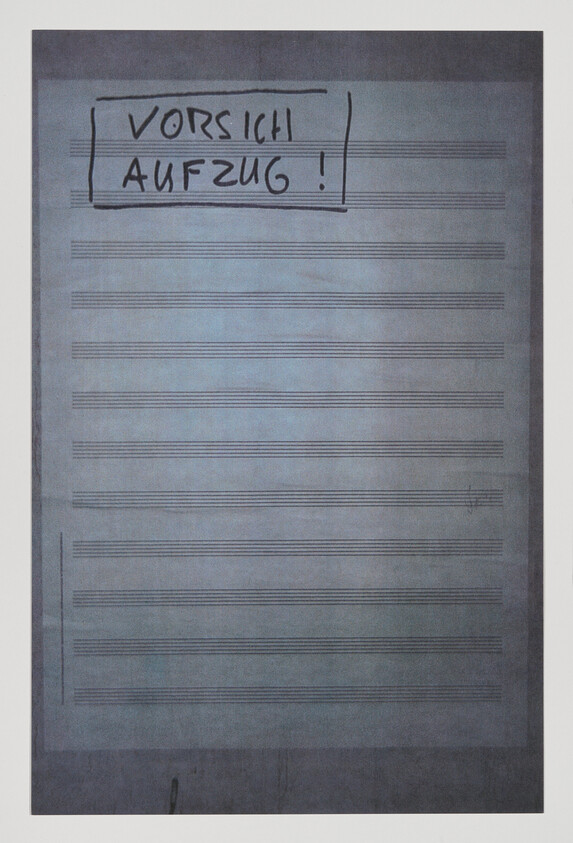 Blank sheet of staff paper with handwritten German warning "Vorsicht Aufzug!" at the top.