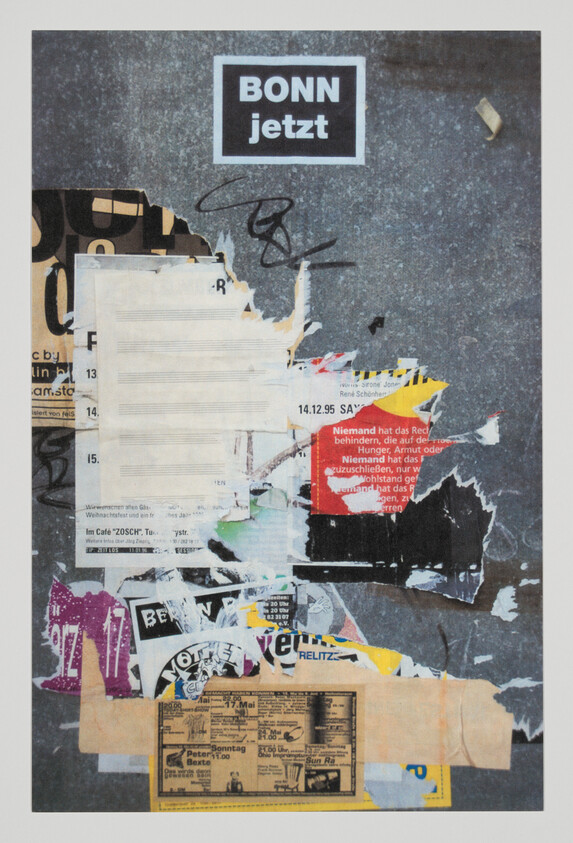 Torn and layered posters on a gray wall with a prominent 'BONN jetzt' sticker at top.