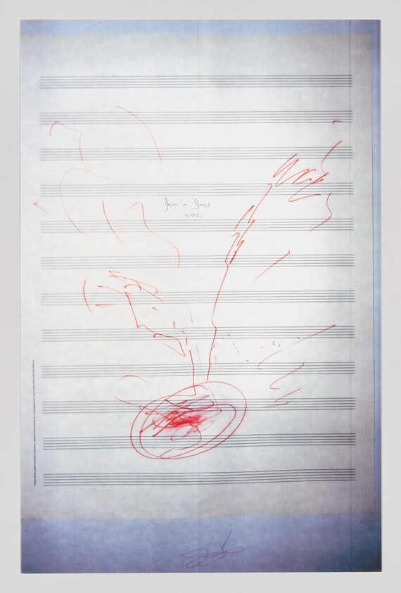 Sheet music with red pen scribbles forming a circular scribble and streaks across the staves.