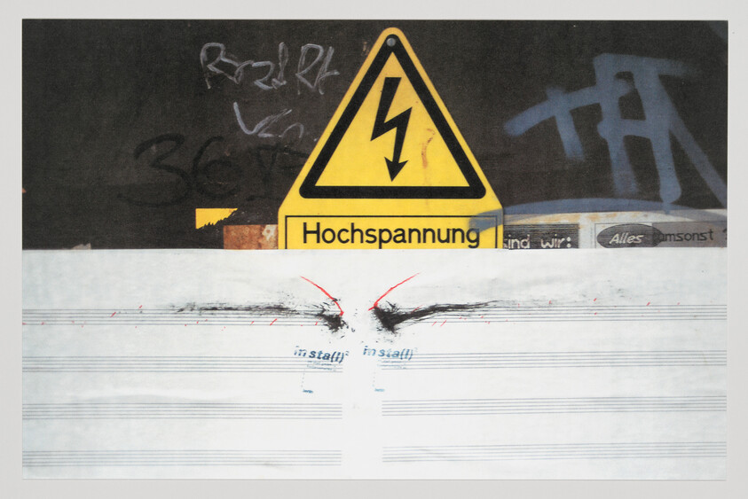 Yellow high-voltage sign labeled 'Hochspannung' above torn paper with burn marks and graffiti.