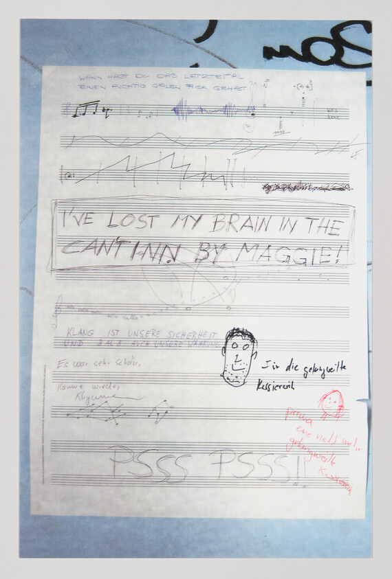 Sheet of handwritten music and doodles with large text reading "I've lost my brain in the canteen, by Maggie."