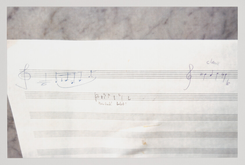 Sheet music page with handwritten treble clefs, short melodic notes, and penciled annotations.
