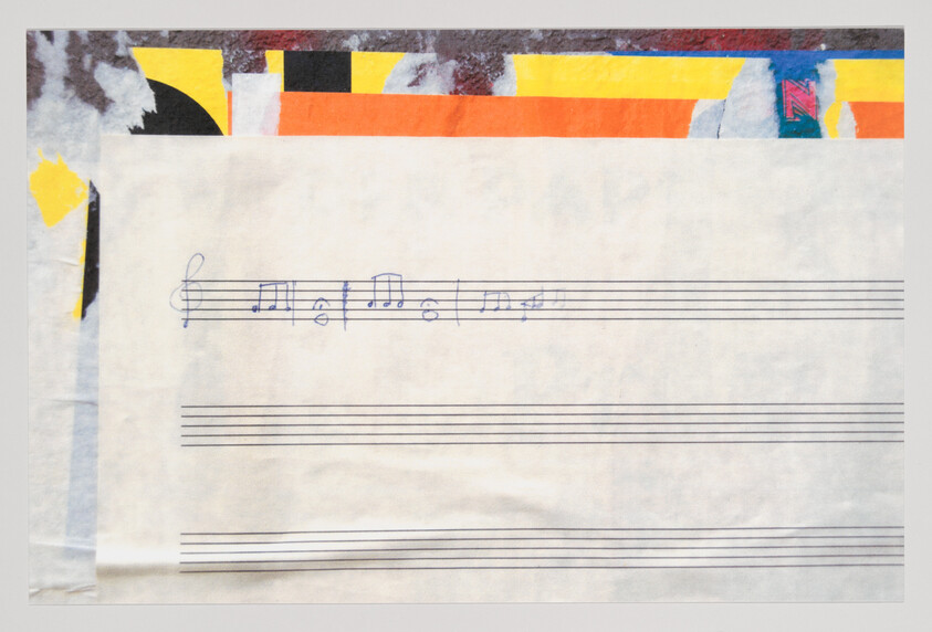 A blank music staff sheet with a short handwritten melody in blue ink across the top staff.