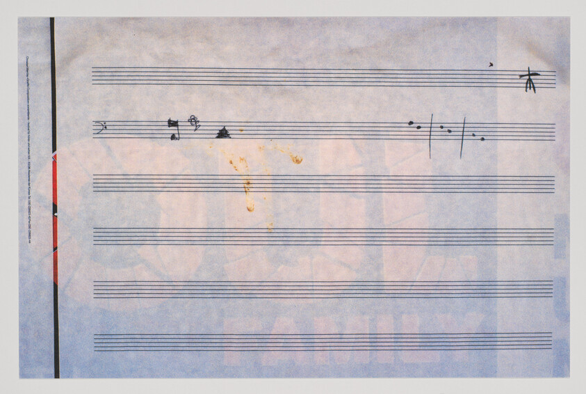 Blank music staff paper with a few hand-drawn notes and small brown stains near the top.