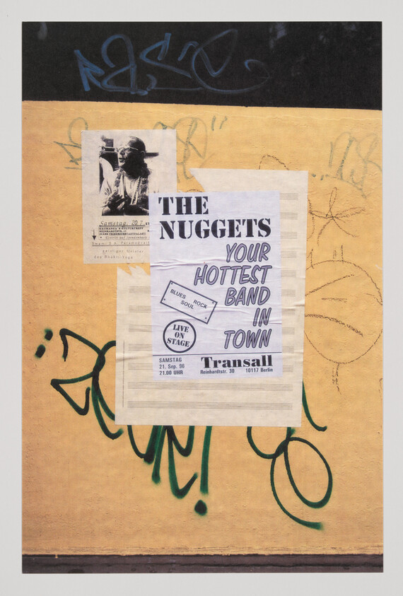 A yellow wall with a poster advertising The Nuggets as "your hottest band in town."