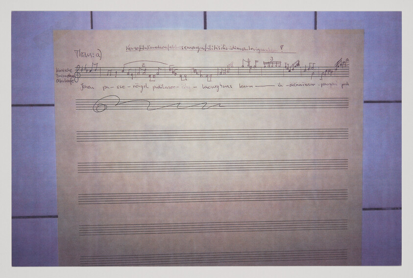 Handwritten musical staff paper with short melody and annotations at the top.