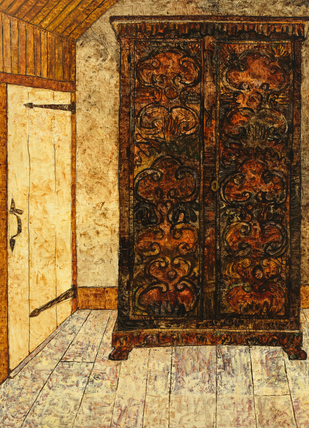 Ornate carved wooden wardrobe standing on a worn wooden floor against a plain wall.