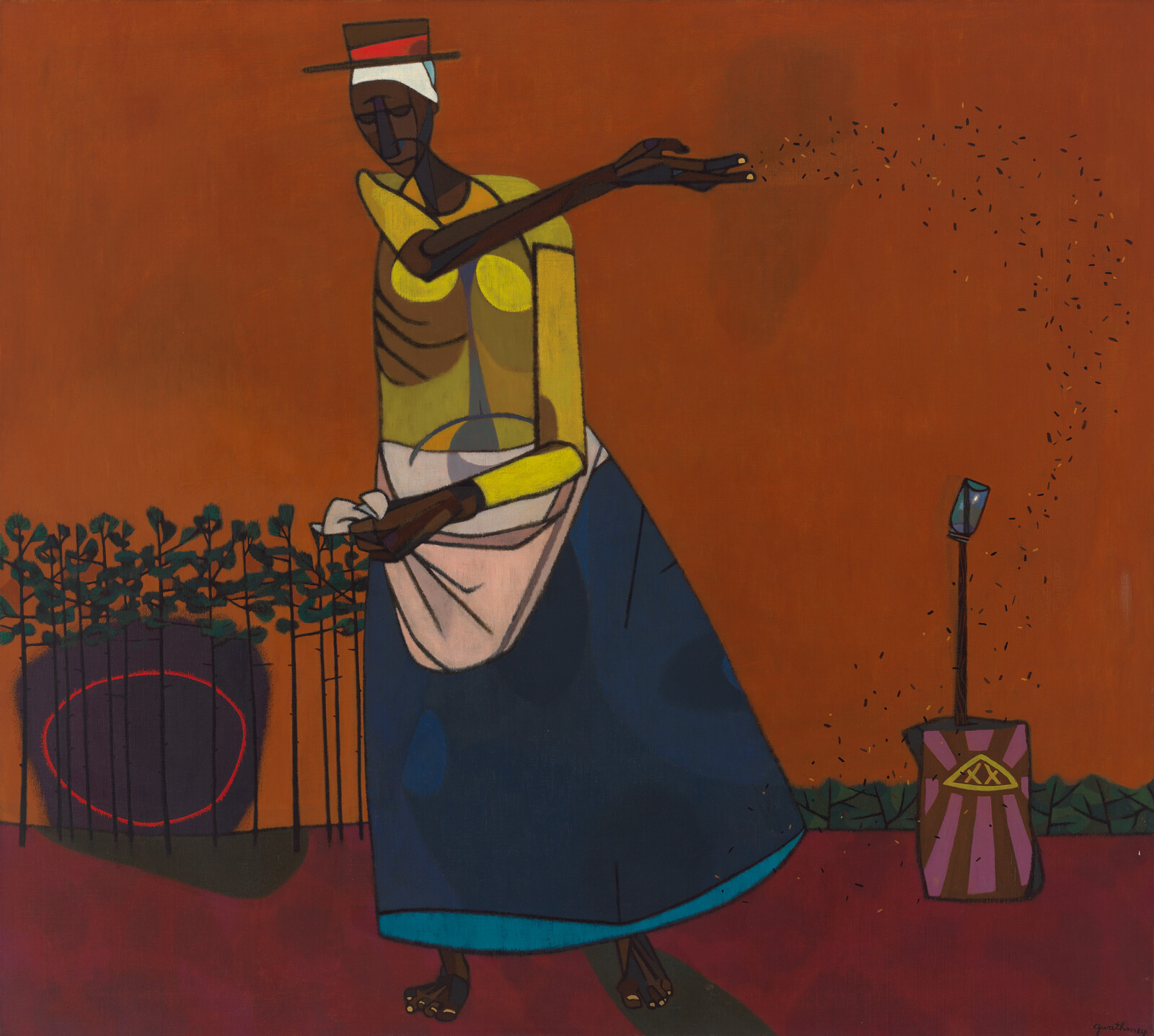 A woman in a hat scatters seeds with an outstretched arm over a reddish field.