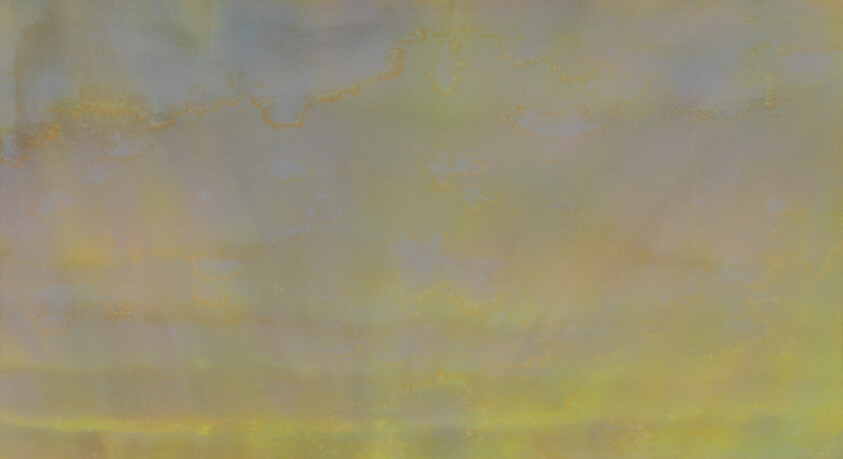 A soft pastel sky with pale yellow and green clouds stretching across the horizon.