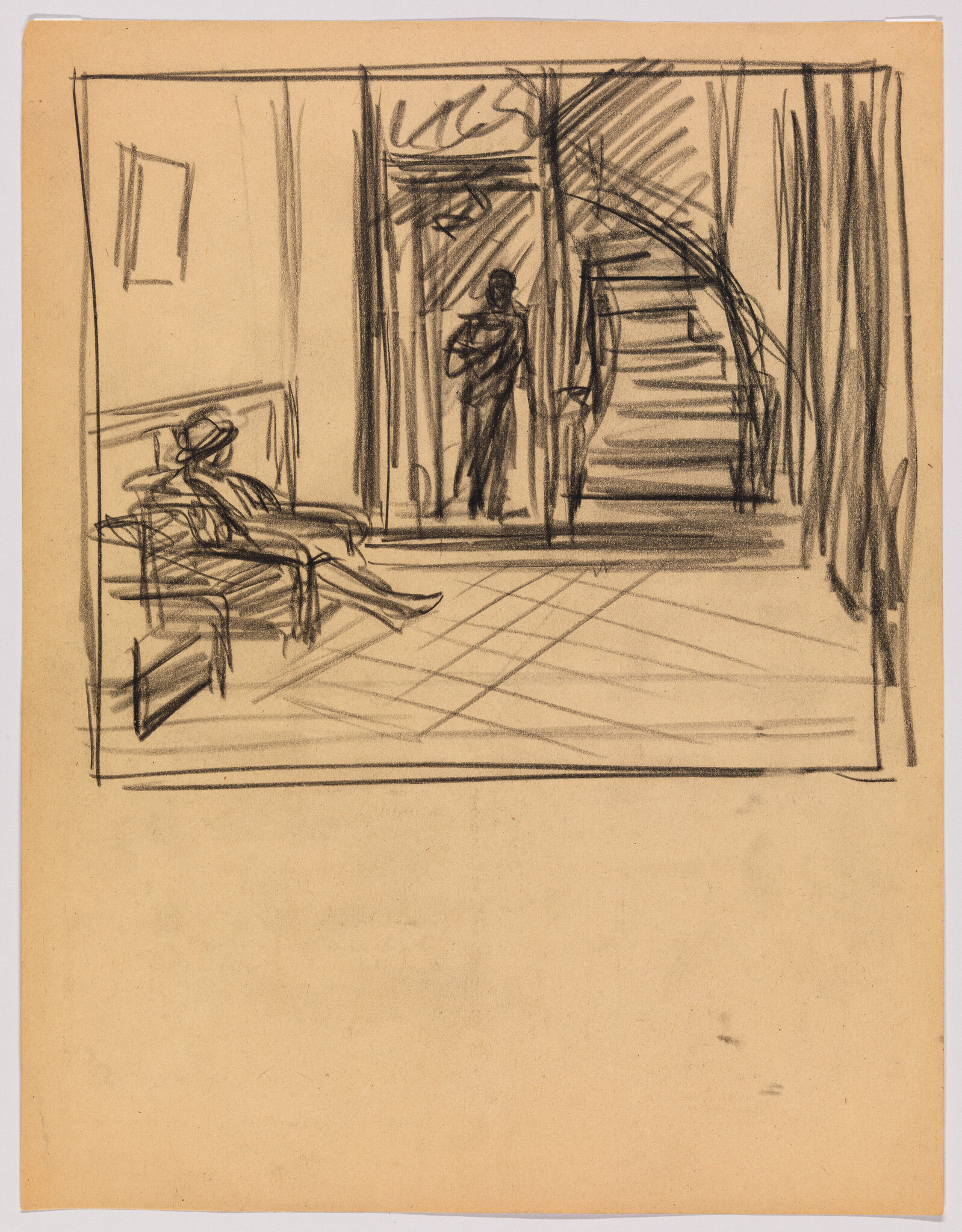 Man in a hat sits on a lobby bench while another person stands by a doorway and stairs.