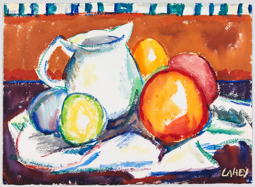 A white pitcher sits among colorful fruit, including peaches and plums, on a cloth.
