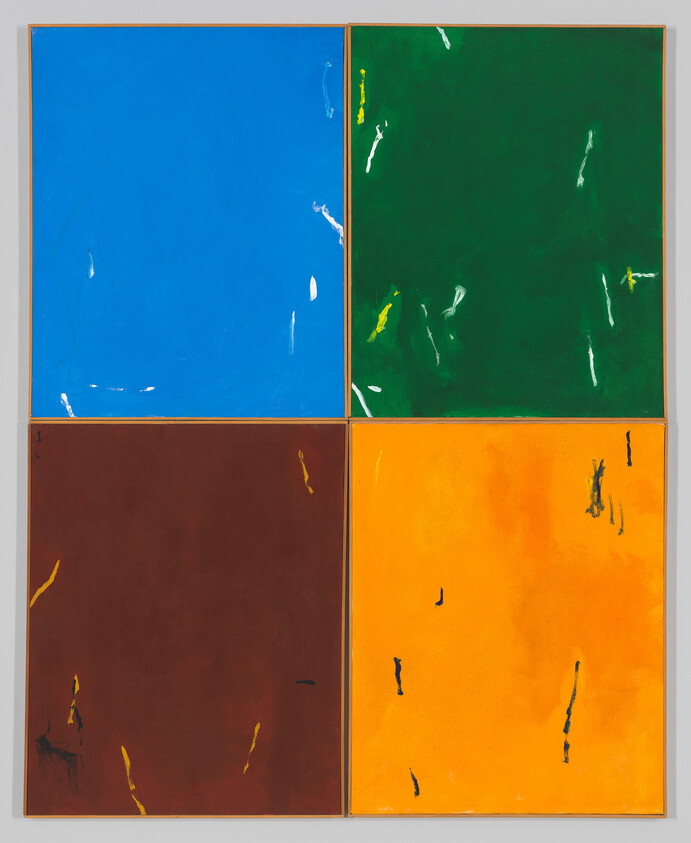 Four large colored panels—blue, green, brown, and orange—each with scattered small paint marks.