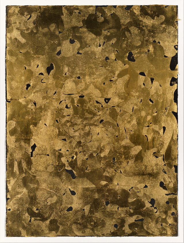 Abstract gold and black textured artwork with scattered dark flecks across a rectangular surface.