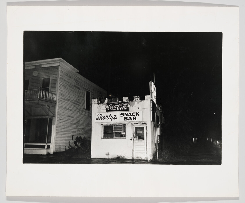 Shorty's snack bar with a Coca-Cola sign stands dark and closed at night.