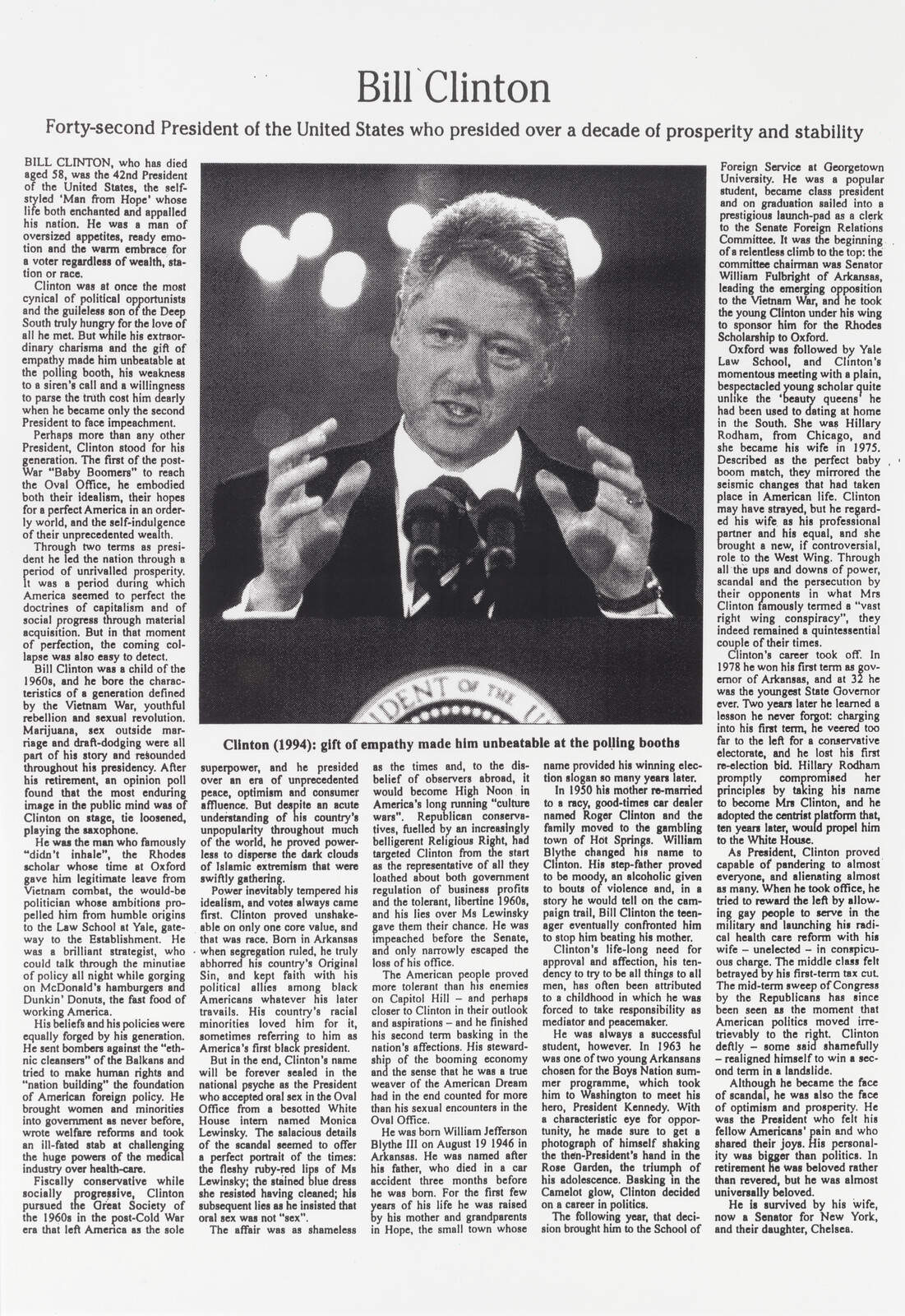 Bill Clinton speaking at a podium, gesturing with both hands in front of a large headline.