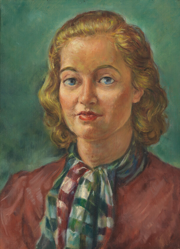 Young blonde woman with blue eyes wearing a patterned scarf and maroon blouse.
