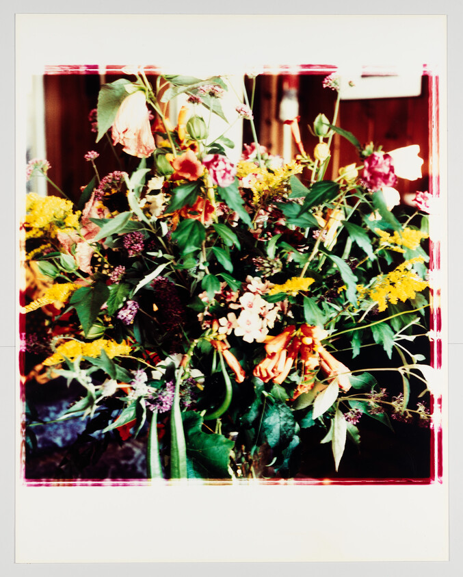 A large mixed bouquet of colorful wildflowers and greenery arranged in a loose, natural style.