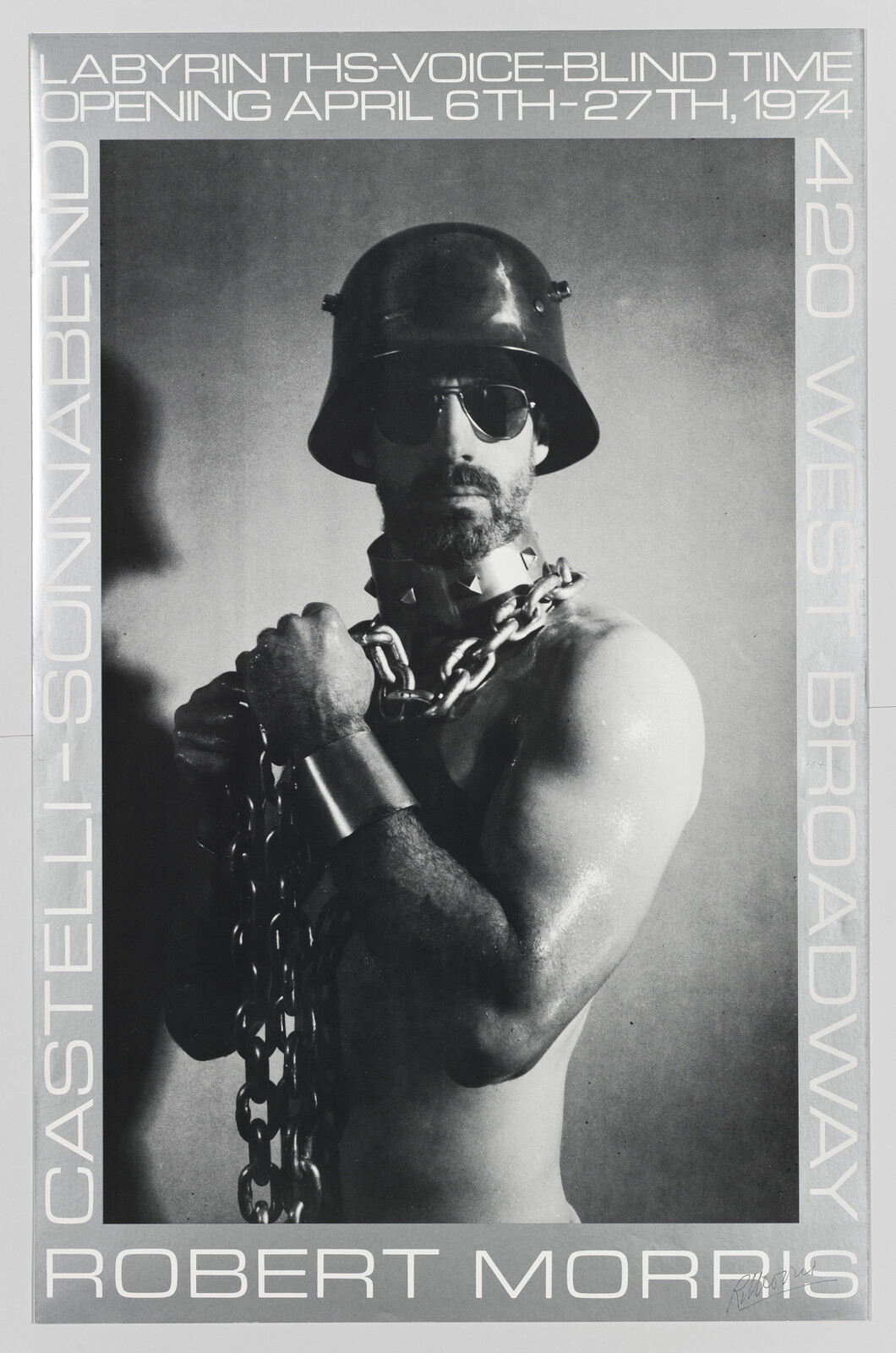 Poster showing a shirtless man wearing a helmet and heavy chains around his neck.