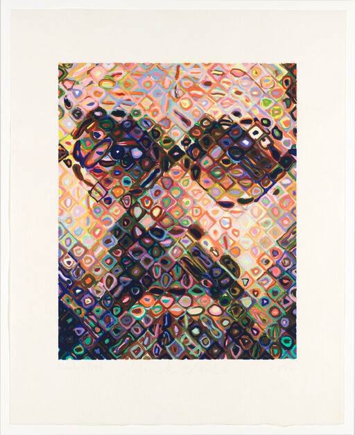 A close-up colorful mosaic portrait of a person wearing glasses made of repeating diamond shapes.