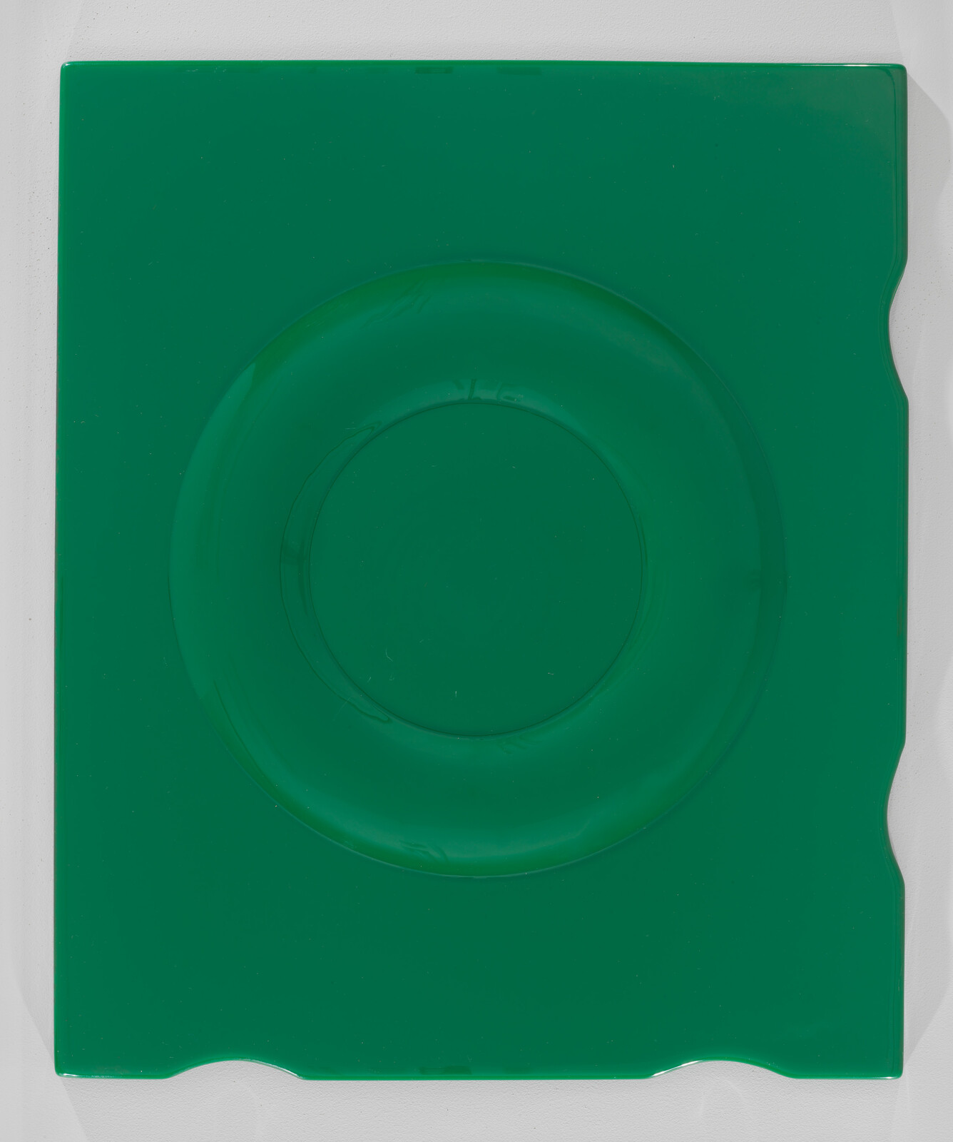 Green rectangular plastic tray with a large circular indentation in the center.