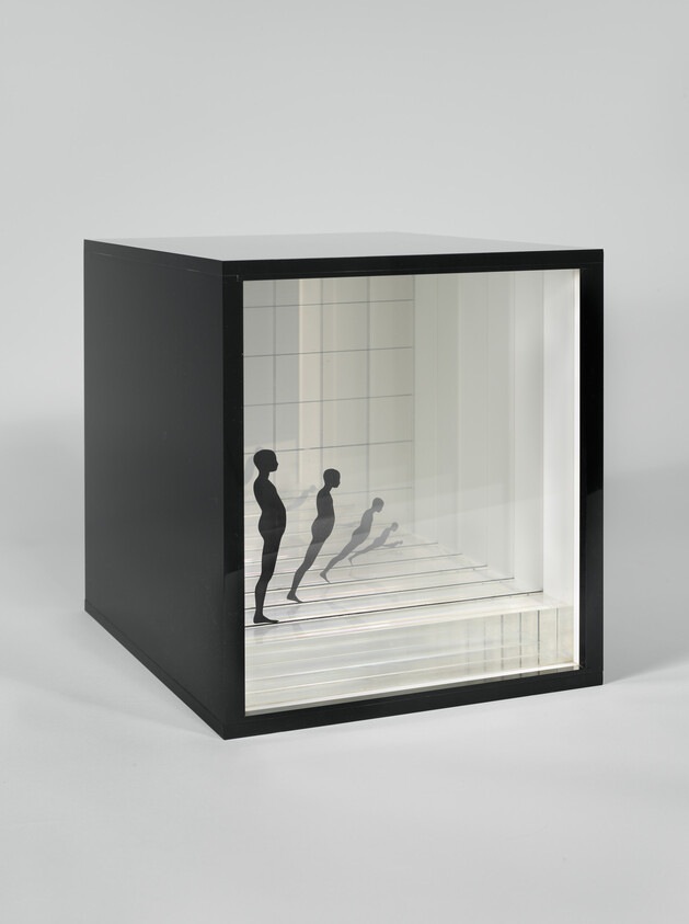 Black cubic display box with mirrored interior reflecting a series of progressively smaller human silhouettes leaning forward.