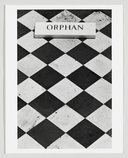 Black-and-white checkered floor with a rectangular plaque labeled orphan near the top.