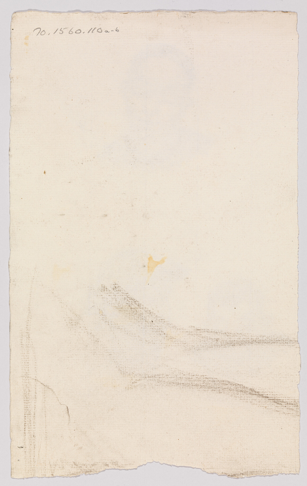 Aged blank paper with faint pencil smudges and a small handwritten notation in the top-left.