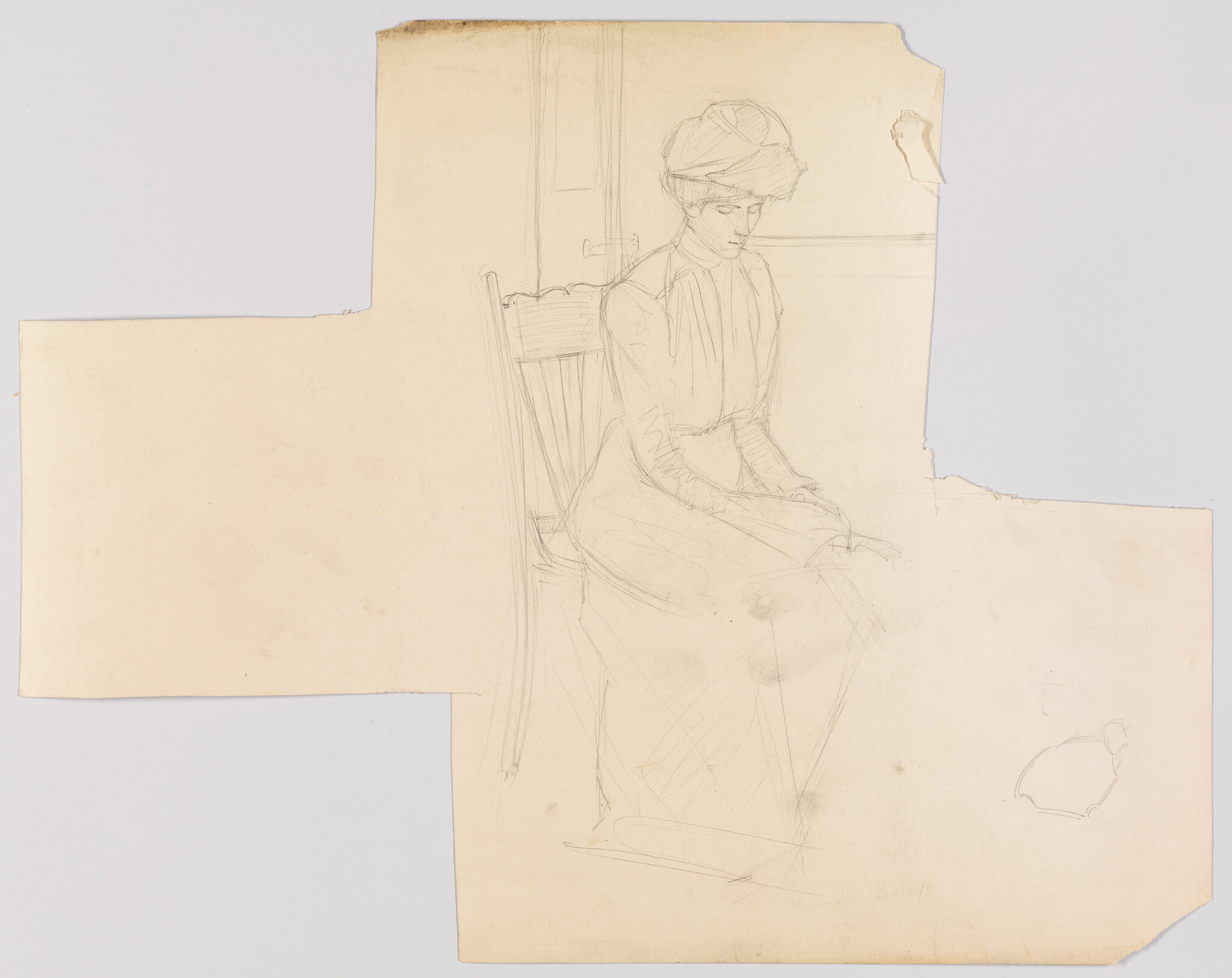 Woman in a long dress and hat sits on a wooden chair with hands folded in her lap.