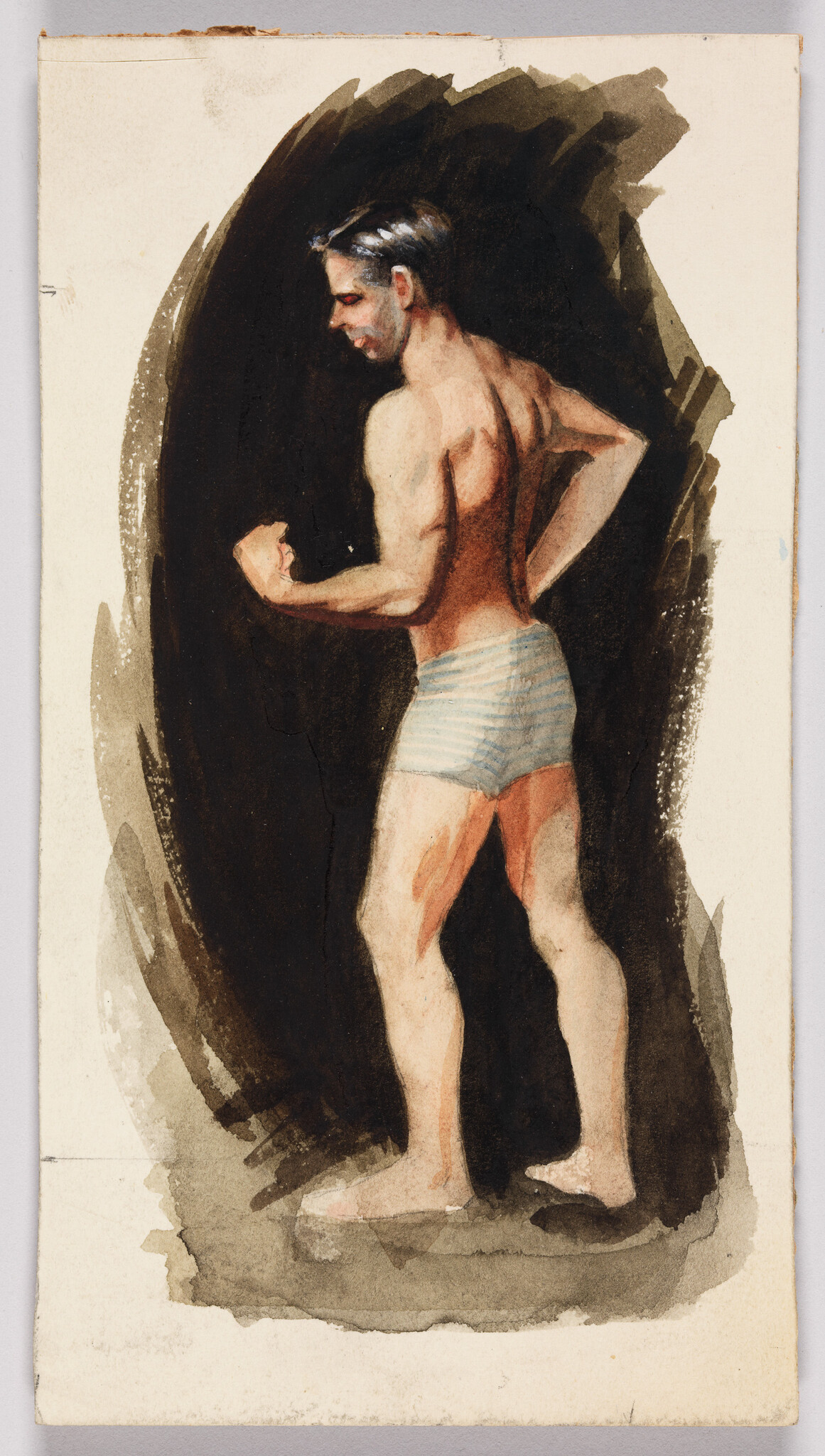 A shirtless man in striped trunks flexes his arm and looks down to his left.