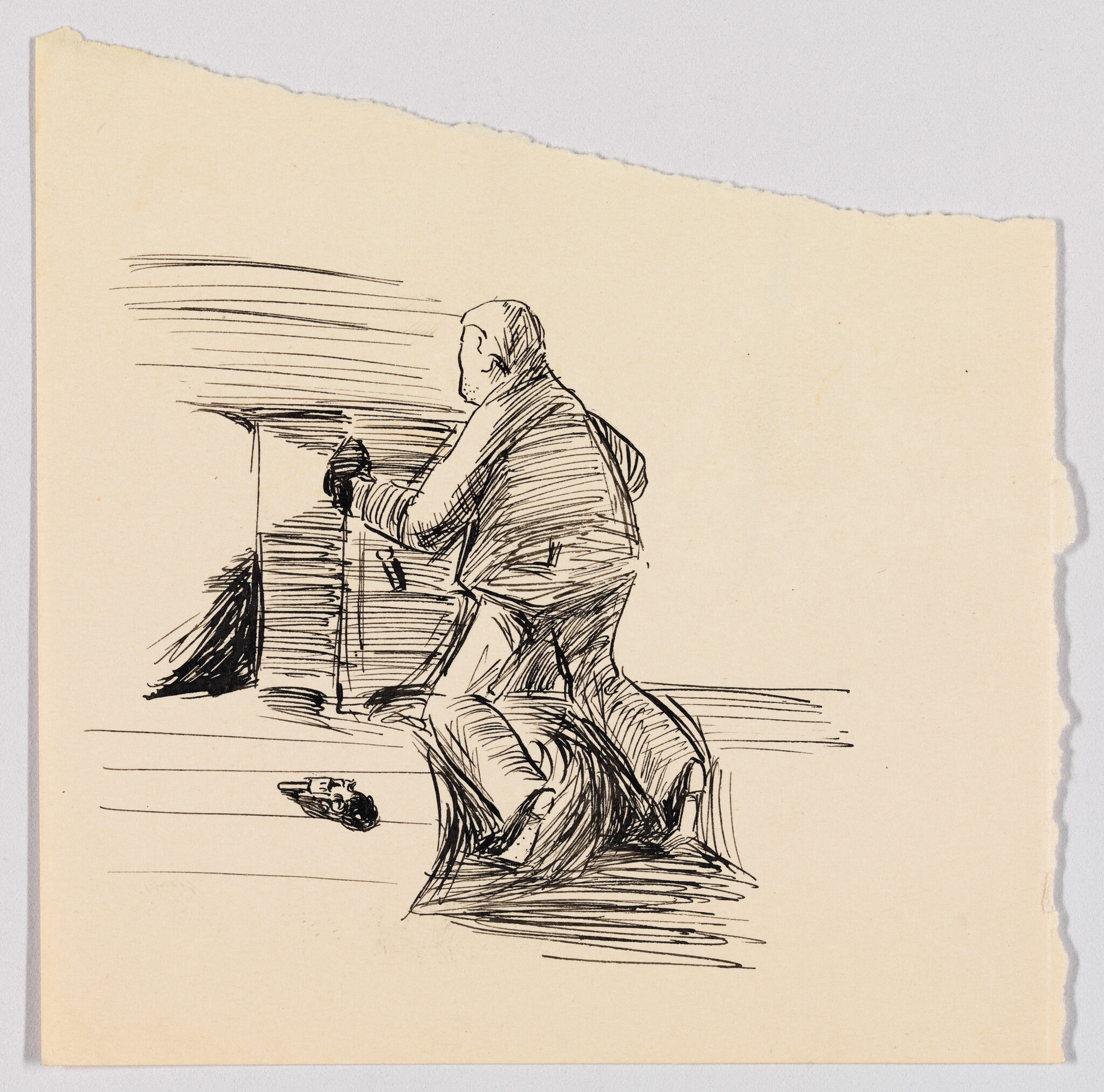 A man kneels over another person near a desk while a small handgun lies on the floor.