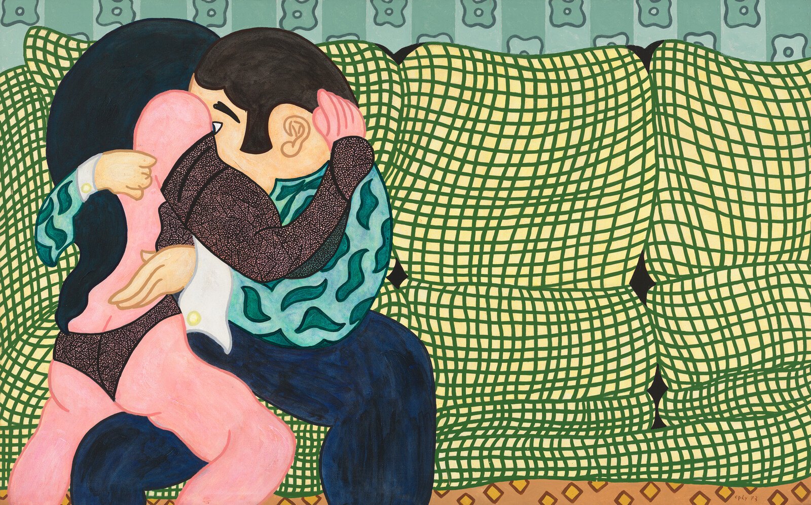 A couple sits closely on a patterned couch, embracing and kissing while wearing colorful clothes.