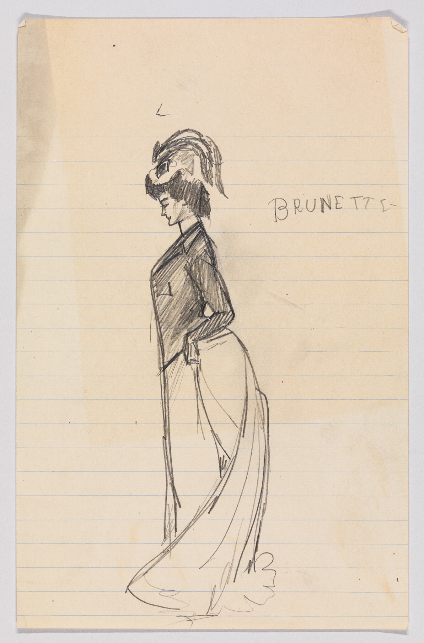 Brunette woman in profile wearing a hat and long skirt with hands on hips.