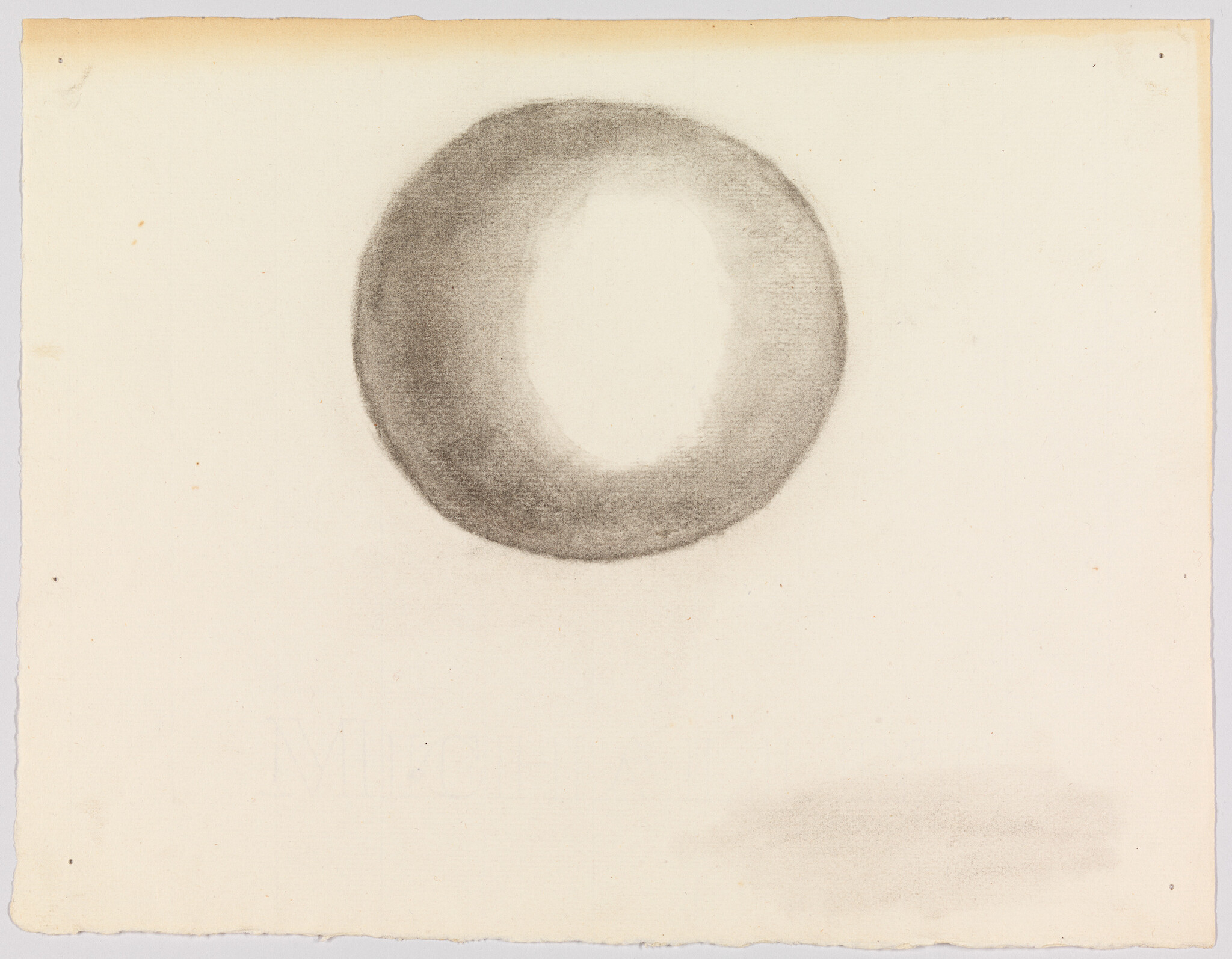 A soft charcoal ring with a light center drawn on blank paper.