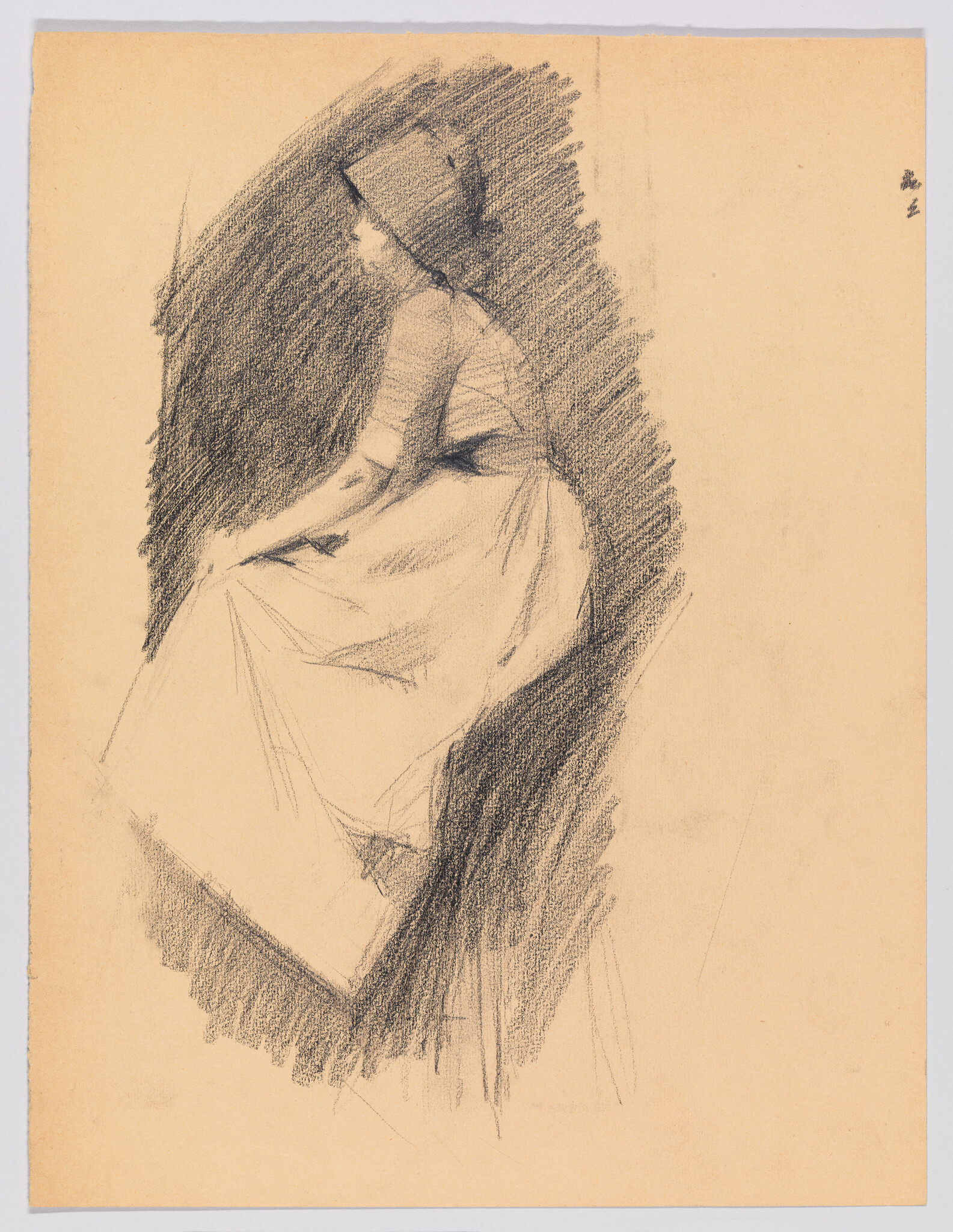 A woman in a hat sits sideways on a chair, hands resting on her lap.