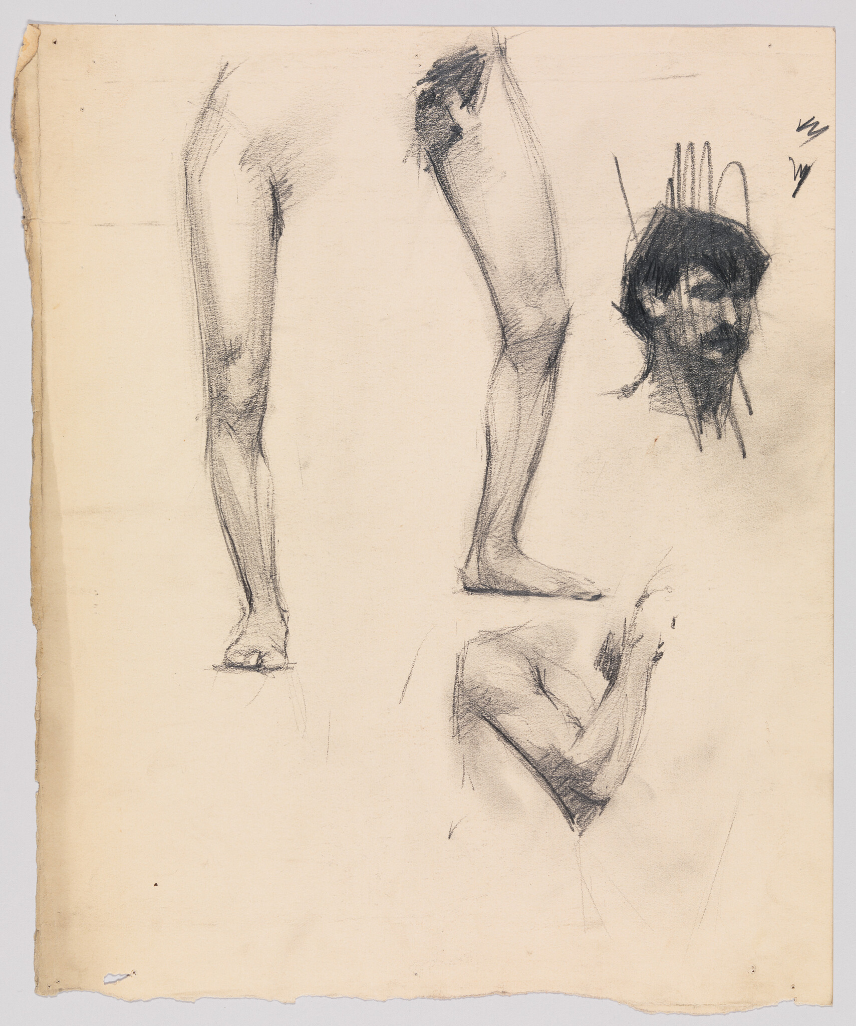 Charcoal sketches showing two legs, a bearded head, and a bent arm on a sheet of paper.
