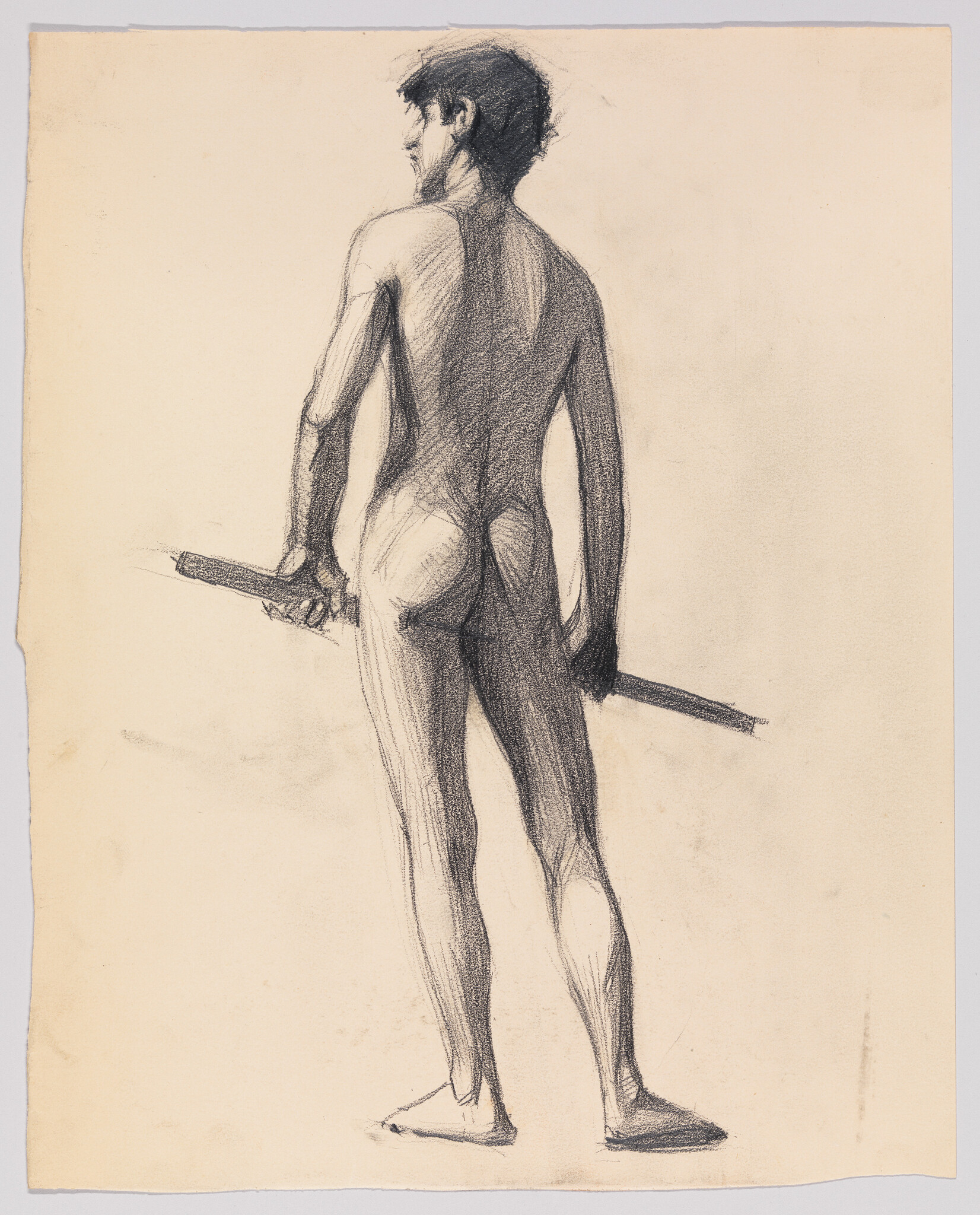 Nude young man standing with his back to the viewer while holding a wooden staff.