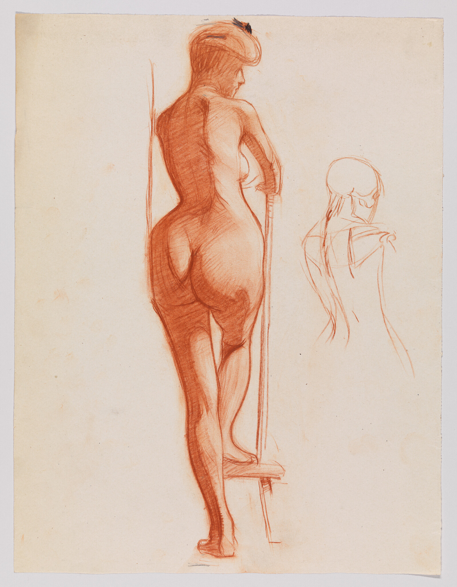 Nude woman standing on a small step and leaning on a vertical pole, back turned.