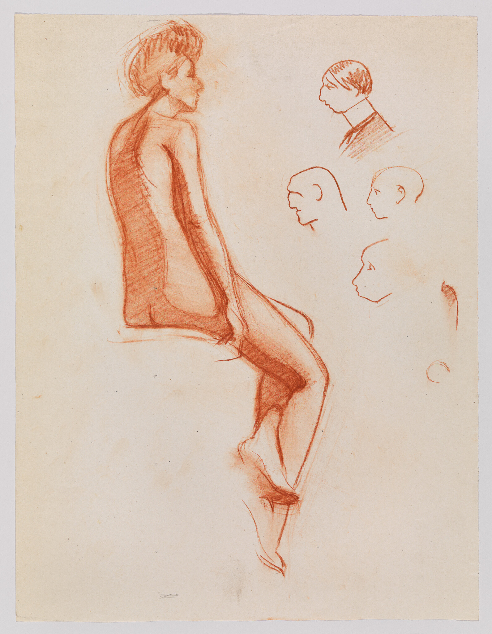 A red chalk sketch of a seated nude woman with several profile head studies nearby.
