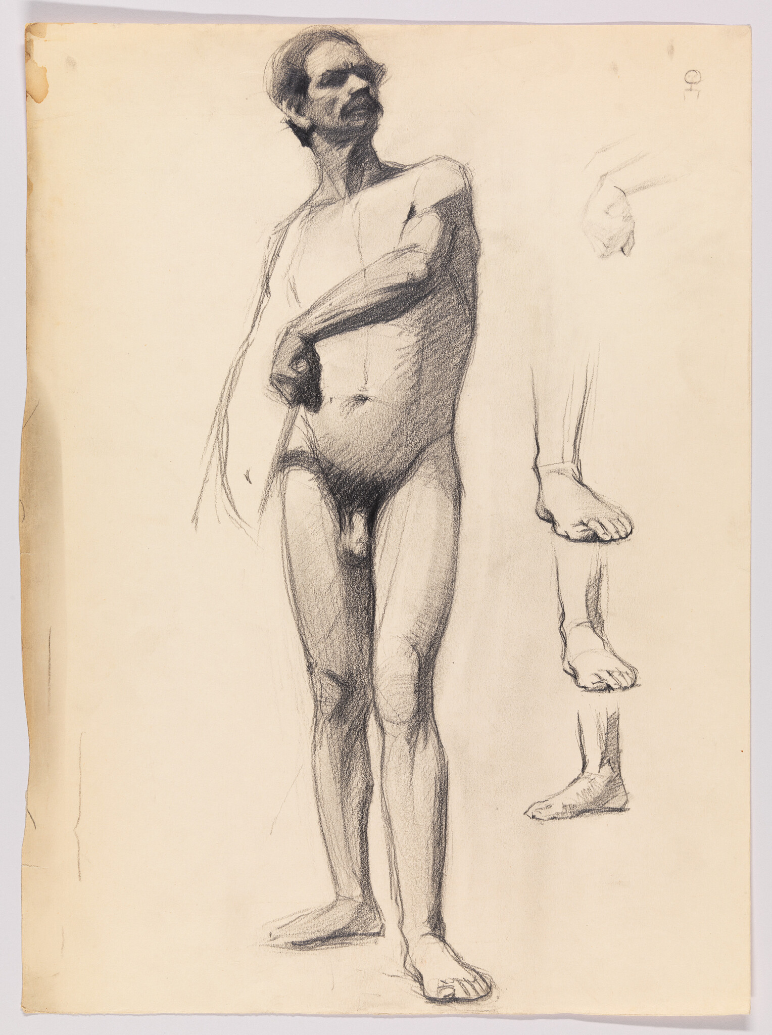 A standing nude male figure drawn in charcoal with right hand on abdomen and foot studies beside him.